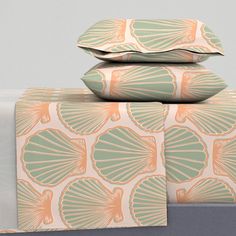 three pillows and two pillow cases are stacked on top of each other