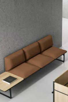 a brown couch sitting next to a wooden table