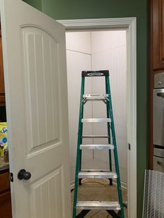 a ladder is being used to paint the walls