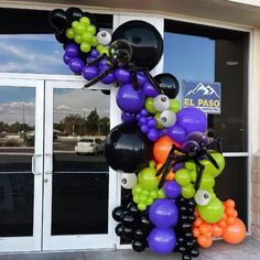 the entrance to an office decorated with balloons and eyeballs for halloween decorations on display