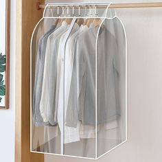 an open closet with clothes hanging on hangers