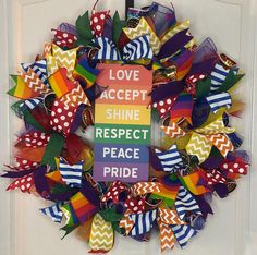 a colorful wreath that says love accept shine respect peace pride