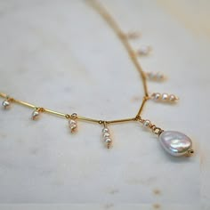 Crafted with attention to detail, this necklace features lustrous freshwater pearls delicately suspended along a gold filled bar chain, creating a mesmerizing design.  Each pearl possesses its unique shape and natural iridescence, adding a touch of organic beauty to the piece. ✶ P R O D U C T ✶ D E T A I L S ✶ +  Gold-Filled 0.91 x 12.61 mm Bar Chain  +  Freshwater Baroque and 2 mm Pearls  ✶ G I F T ✶ P A C K A G I N G ✶  + Each piece is carefully packaged in an elegant microfiber pouch or a box Pearl Necklace Designs Unique, Pearl Drop Necklace, Pearl Necklace Designs, Baroque Pearl Necklace, Etsy Bridesmaid Gifts, Dream Jewelry, Drop Necklace, Organic Beauty, Gold Pearl