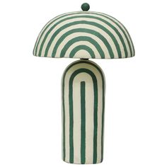 a green and white table lamp with a striped shade on it's top, sitting in front of a white background