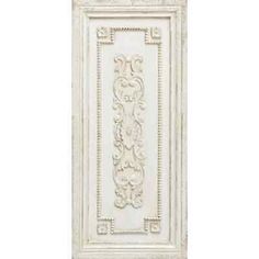 a white wall hanging with an ornate design on the front and back of it's frame