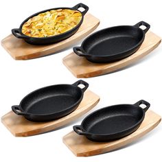 three cast iron skillets on wooden serving trays