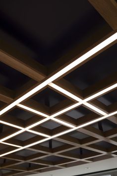 the ceiling is made up of square and rectangle shapes with white lights on them