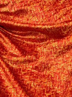 an orange and red cloth with small black dots on it's edges, as well as the background