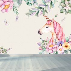 a room with floral wallpaper and a unicorn mural on the wall next to a wooden floor