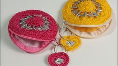 two crocheted items are sitting next to each other on a white table top