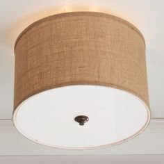 a light that is on the ceiling with a lamp shade hanging from it's side