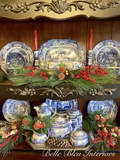 blue and white china is displayed on a shelf