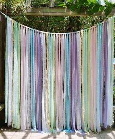 multicolored streamers hanging from a wooden fence