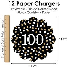 a black and gold polka dot paper charger with the number 100 on it