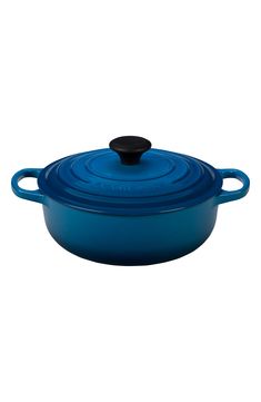 a blue casserole dish with a black lid and an oval handle on the side