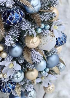 a christmas tree decorated with blue and gold ornaments