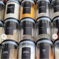 many jars filled with different types of spices and seasonings on top of each other