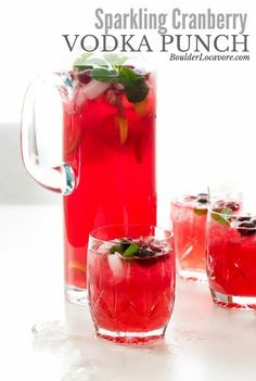 three glasses filled with red liquid and garnished with mint