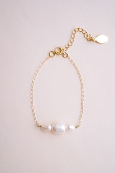 Introducing our Cosette Pearl Bracelet, a delicate and elegant piece of jewelry that is perfect for weddings or any formal occasion. This dainty gold chain bracelet features beautiful freshwater pearls that are hand wire-wrapped with a 14k yellow gold-filled chain, creating a stunning and timeless look. FEATURES Material: 14k Gold Fill, Freshwater Pearls Dimensions: 6" with a 2" extender Dainty Pearl Bracelet, Dainty Gold Chain, Gold Pearl Bracelet, Dainty Gold Bracelet, Gold Chain Bracelet, Beaded Necklace Designs, Chain Bracelets, Jewelry Lookbook, Pretty Stuff