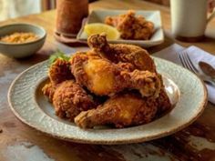 fried chicken is piled on a plate at a restaurant