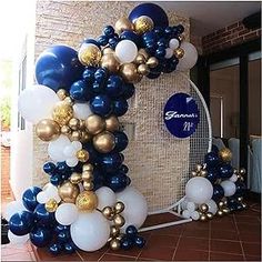 the balloon arch is decorated with blue, white and gold balloons