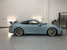 a blue sports car parked in a garage