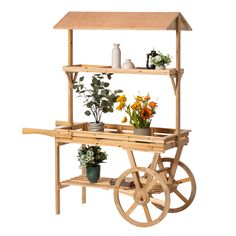 a wooden cart with flowers and potted plants on it