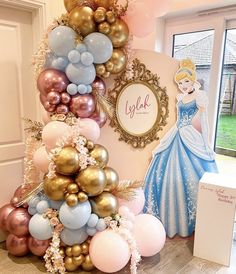 the balloon tree has been decorated with princesses and balloons for an elegant birthday party