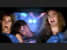 two men and a woman are in the back of a car with their mouths open