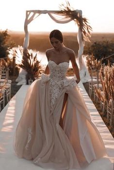 a woman in a wedding dress is walking down the aisle