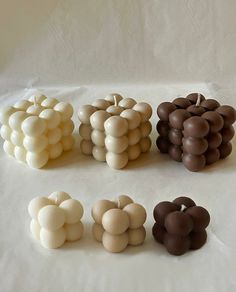 there are many different types of chocolates on the white tablecloth, including apples and grapes