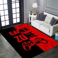 a living room with a couch, chair and rug that says gamer zone on it