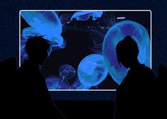 two people are looking at jellyfish in an aquarium with blue light coming from the screen