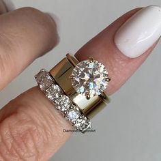 a close up of a person's hand with a ring on it and a diamond