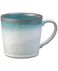 a blue and white coffee cup with gold rim