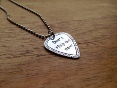 a heart shaped necklace with the words don't storm my way on it