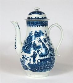 a blue and white tea pot with a sailboat on it's lid is shown