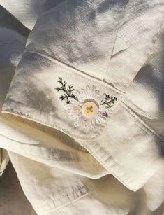 a white shirt with embroidered flowers on it