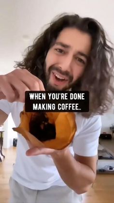 a man holding a doughnut with the caption when you're done making coffee