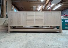 a large wooden cabinet sitting inside of a building