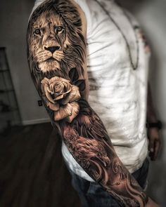 a man with a lion and roses tattoo on his arm