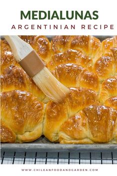 a wooden spatula is being used to make croissants in the oven