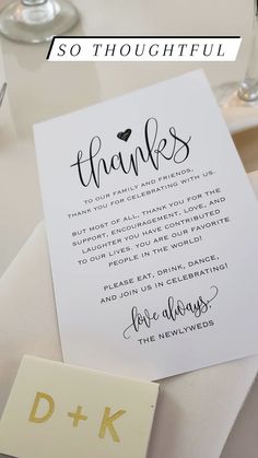 a thank card with the words thanks written on it next to some wine glasses and silverware