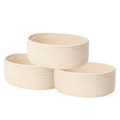 three white rope baskets sitting on top of each other