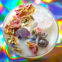 a plate with some rocks on it in front of a holographic background that is multicolored