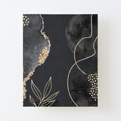 a black and gold painting on a white wall