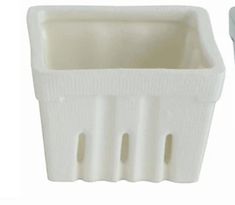 a white plastic container sitting next to a toothbrush holder