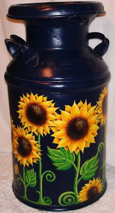 a blue vase with sunflowers painted on it