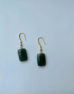 A pair of elegant rectangle-shaped dark green jade cube earrings with 14k gold ear wire. They are made from high-quality real Chinese jade and 925 sterling silver plated with 14k gold. Simple and minimalistic design works great for all sorts of occasions: dating, daily wear, home or office, you name it. Perfect as a gift for your loved ones or yourself. Highlights: ♥ High-quality materials Hand-made with quality dark green jade, paired with 925 sterling silver plated with 14k gold. Ensure long last wear and they are friendly for sensitive skin. ♥ Simple and minimalistic design Great for all sorts of occasions and perfect for gifting  ♥ Measurements Each drop is measured 1.5cm diameter and 2.5cm long. ♥ 100% Satisfaction Guarantee Gift-worthy packaging included! Please include a message if Cheap Green Minimalist Jewelry, Cheap Green Danglers Perfect As Gifts, Cheap Bohemian Green Earrings, Handmade Jade Earrings, Affordable Handmade Jade Earrings, Affordable Jade Bead Earrings, Cheap Everyday Green Earrings, Elegant Green Rectangular Earrings, Formal Rectangular Jade Jewelry