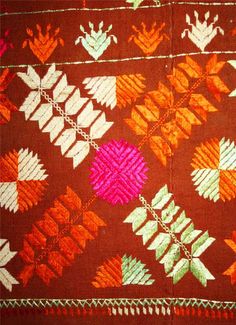 an orange, pink and green pattern on fabric